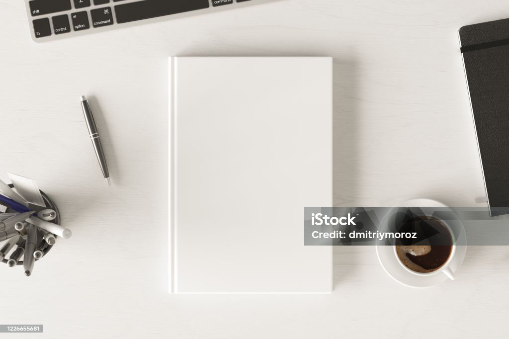 Book cover mock up. Workspace on wooden desk with cup of coffee Vertical book cover mock up. Workspace on white wooden desk with cup of coffee. View directly above. 3d render. Book Stock Photo