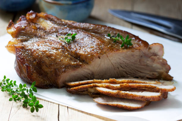 istock Baked pork shoulder on the bone with spices, herbs and aromatic oil. 1226655694