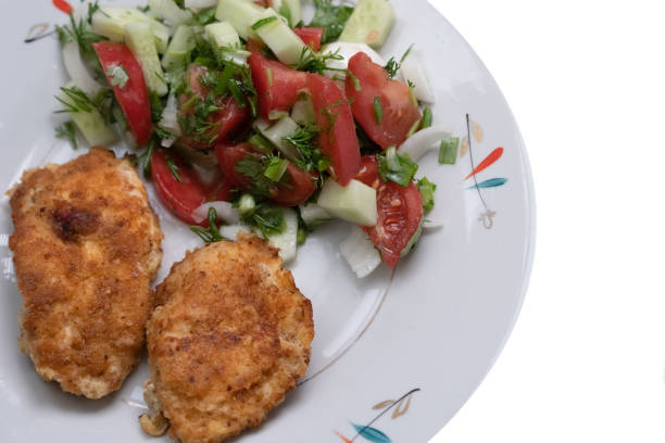 istock Fried chicken slices in breadcrumbs with salad on a plate 1226655826