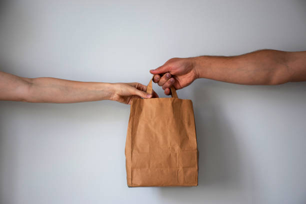istock Courier gives paper package to client 1226656020