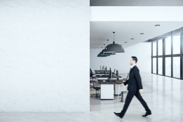 istock Businessman walking in office interior hall 1226659469