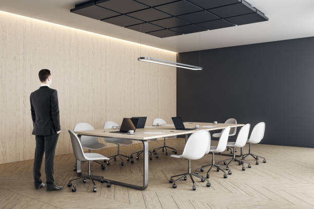 istock Businessman standing in modern conference interior 1226659489