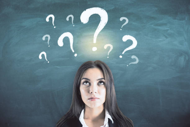 istock Thoughtful businesswoman with drawn question marks 1226659892