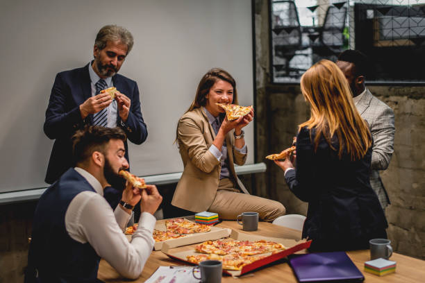 istock Business people talking and having pizza on lunch break at office 1226661733