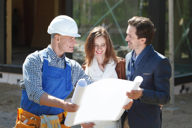 istock Foreman and couple with blueprint 1226663612
