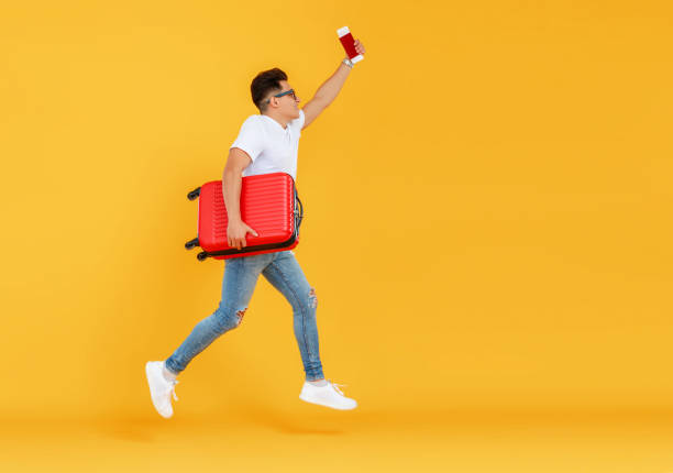 Male tourist jumping and taking selfie