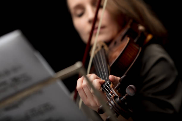 istock Woman playing a classical violin during a recital 1226664439
