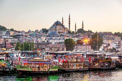 Eminonu district with many facilities to eat such as floating restaurants and carts with fresh bakery, hot corn or roasted chestnuts in Istanbul, Turkey.