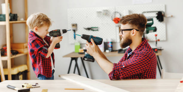 istock Father and son having fun with drills in workshop 1226664506