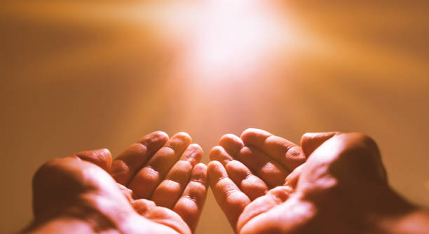 istock Muslim man praying. Ramadan kareem concept: Muslim prayer open two empty hands up on light background 1226664554