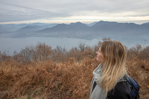 The sun rises through the clouds in the distance, Lake Maggiore, Piedmont