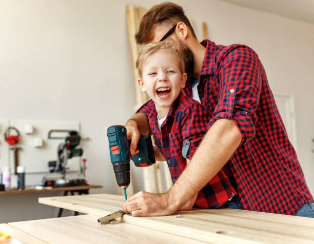 istock Happy kid helping father in carpentry studio 1226667341