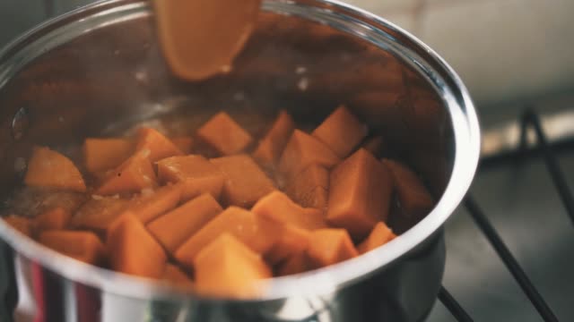 Cooking stewed boiling pumpkin stell pan slow motion
