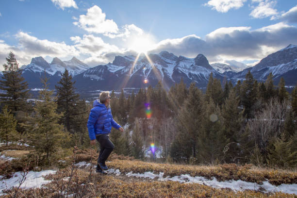 istock Man watches the sun rise over distant snowcapped peaks 1226668037