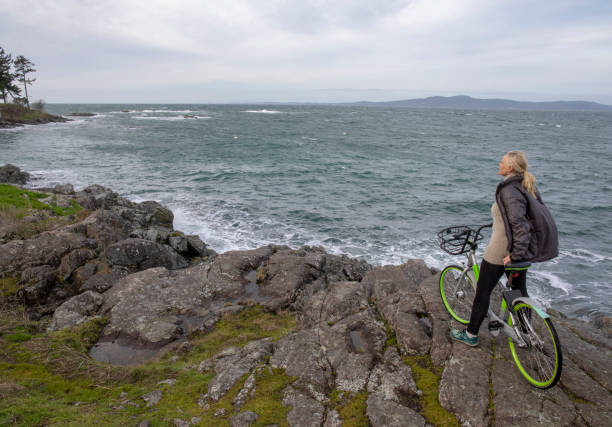 istock Woman explores rugged coastline on commuter bicycle 1226668853