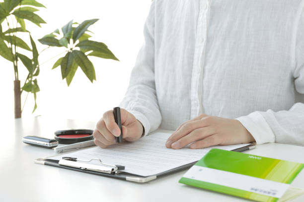istock Japanese woman signing contract 1226673295