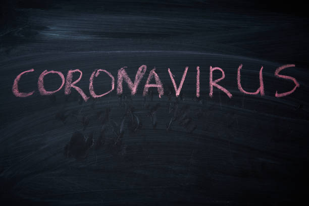 istock Outbreak Warning. written white chalk on blackboard in connection with epidemic of coronavirus worldwide. 1226673476