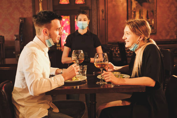 istock Couple eating at bar reopening after quarantine restriction 1226678702