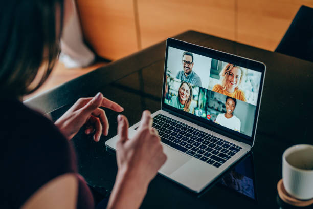 Friends in video call Shot of young woman talking to her friends in video call from home. Multi-ethnic group of people using laptop for a online meeting in video call. Friends having online conversation during quarantine. video still stock pictures, royalty-free photos & images