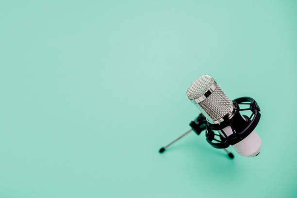 istock White metalic microphone on neomint background. Top horizontal view copyspace. Interview and podcast concept. 1226688394
