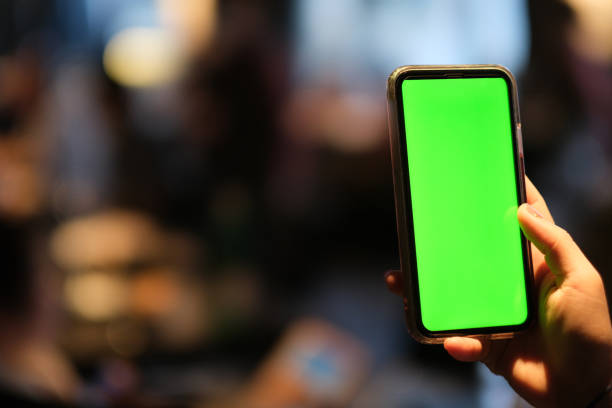 istock close up one hand tapping green screen smart phone. 1226688472