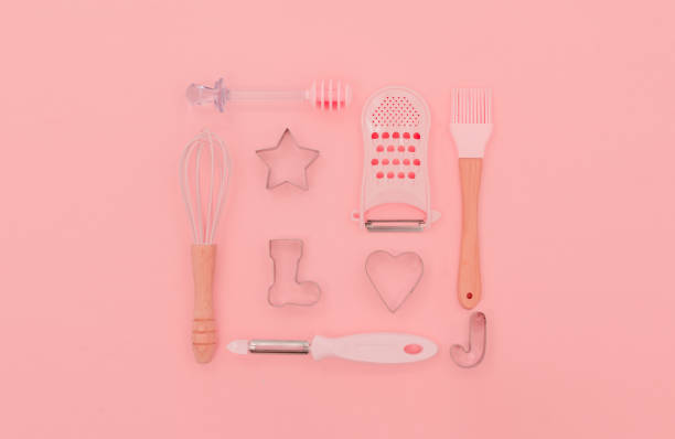 istock Various pink kitchen utensils on abstract pink background. Greater, whisk and iron cooking form. Top horizontal view copyspace love cookong concept 1226688523
