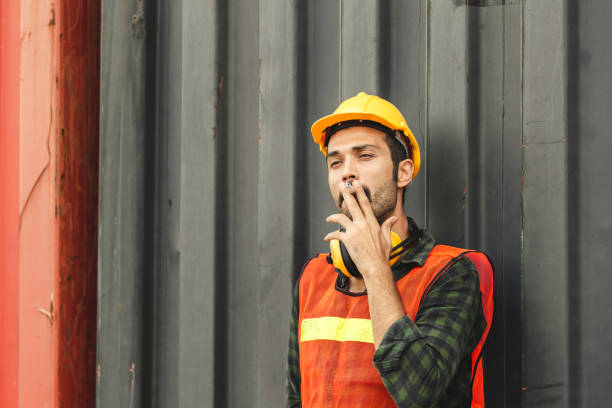 istock Worker with a cigarette smoke break, Labour takes a cigarette break 1226691424