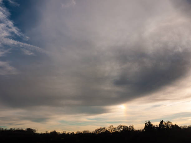 istock dark cloudy moody sky over tree line silhouette background landscape 1226693843