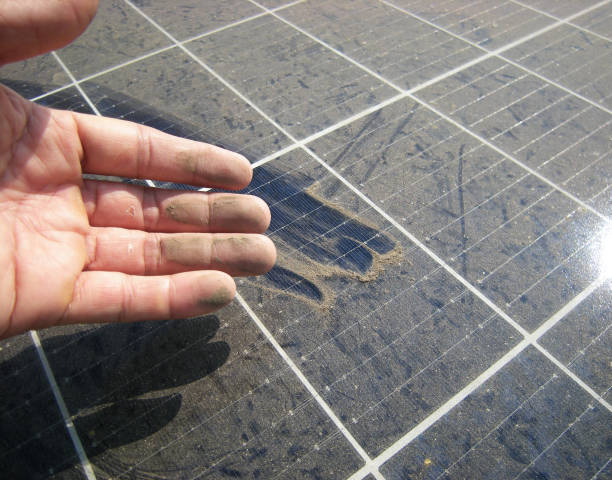 Dirty Hand after Rubbing Dusty Solar Panel stock photo