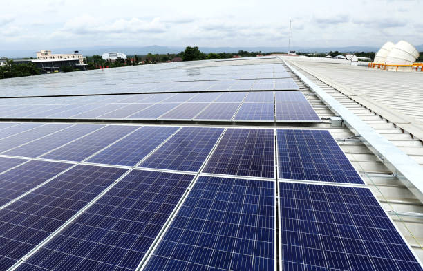 istock Solar PV on Industrial Roof with Cooling Tower Background 1226698741