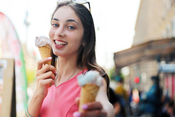 istock Beautiful girl eating ice cream 1226704067