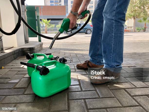 Filling Fuel Cans Stock Photo - Download Image Now - Gas Can, Gasoline, Container