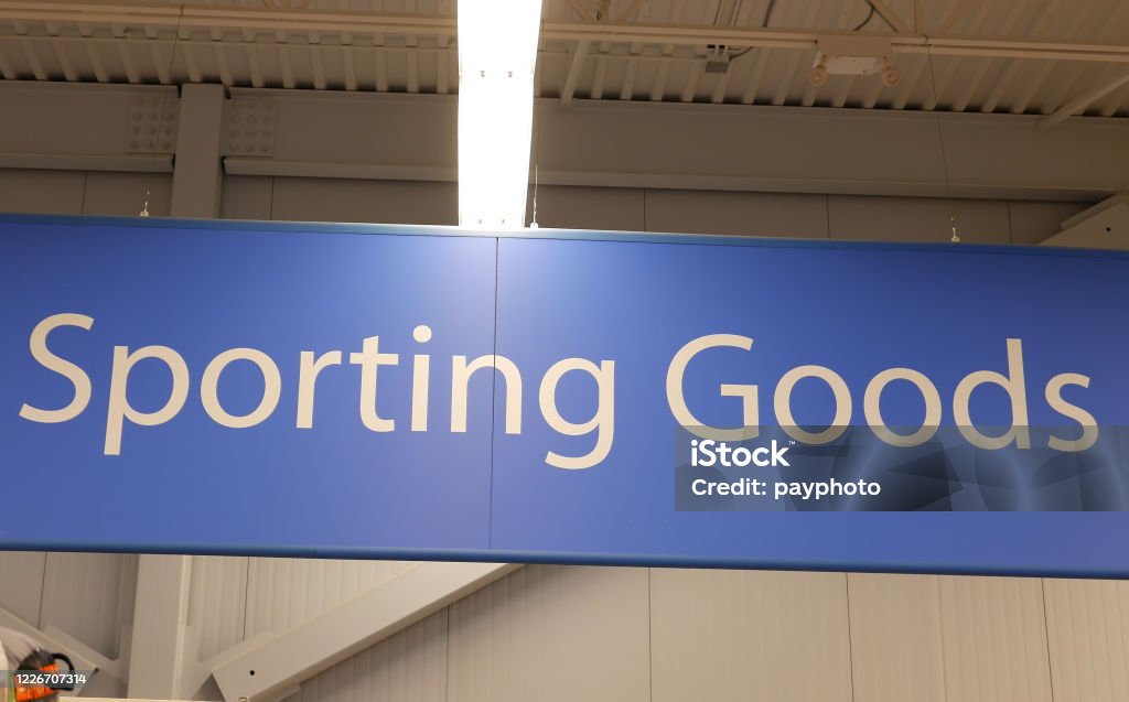 Motion of sporting good sign on sport equipment section inside Walmart store Business Stock Photo