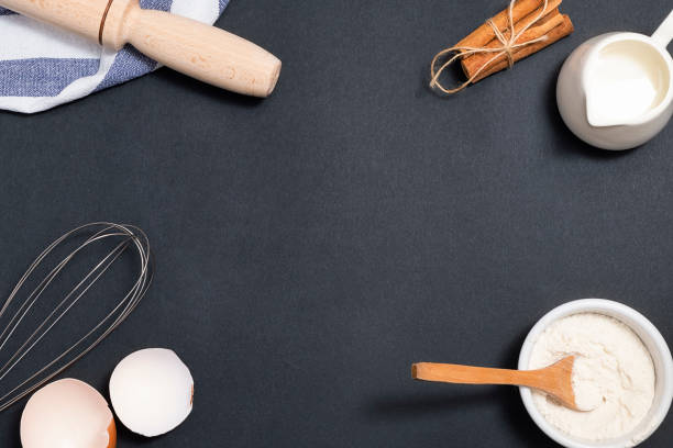 istock Baking background. Cooking ingredients for dough and pastry on black background, above view with space for text. Mockup for menu, recipe 1226708317