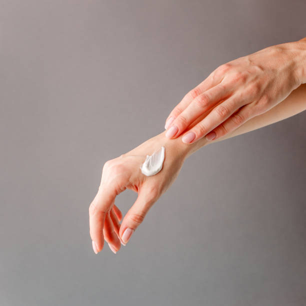 istock Closeup on woman's hands applying moisturizing hand-cream on, minimal background, beauty industry spa salon stylish banner, flyer, coupon, copy space 1226708327