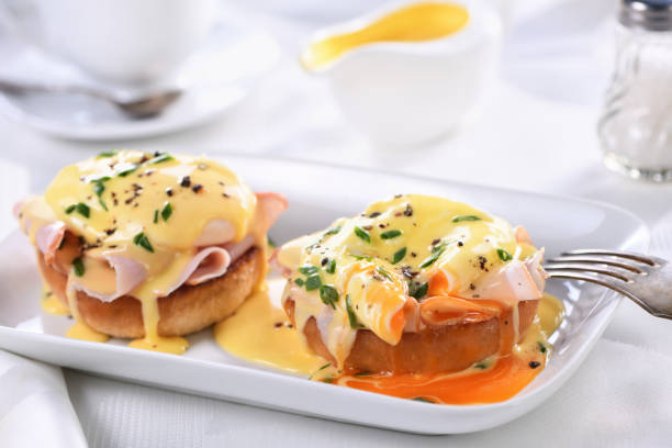 istock Breakfast. Best Eggs Benedict - fried English bun, ham, poached eggs and delicious Hollandaise   butter sauce 1226708378