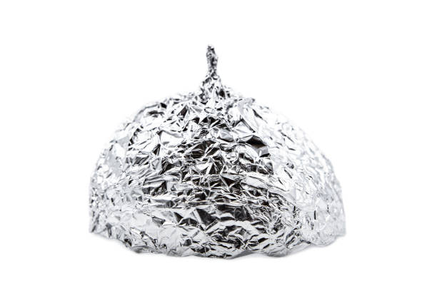 Tin foil hat isolated on white background, symbol for conspiracy theorie and mind control Tin foil hat isolated on white background, symbol for conspiracy theorie and mind control tin foil hat stock pictures, royalty-free photos & images