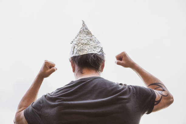 Man with a tin foil hat on his head demonstrate angry, concept conspiracy theory and schwurbler Man with a tin foil hat on his head demonstrate angry, concept conspiracy theory and schwurbler tin foil hat stock pictures, royalty-free photos & images