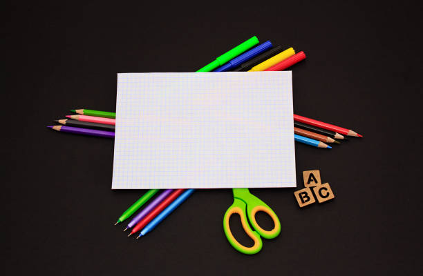 istock School accessories on black paper background 1226710843