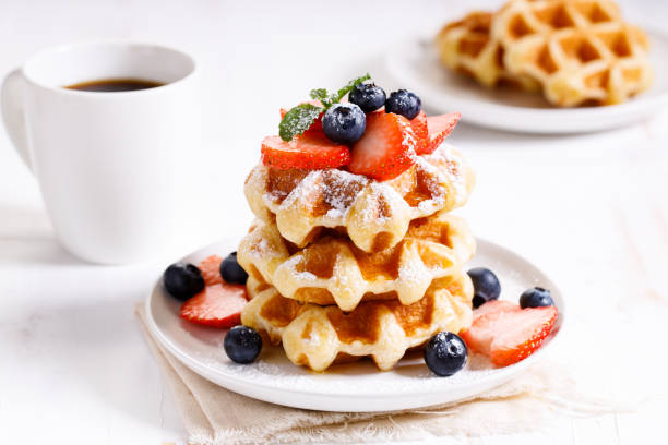 istock belgian waffles with fresh blueberries, strawberries and sugar. 1226711683