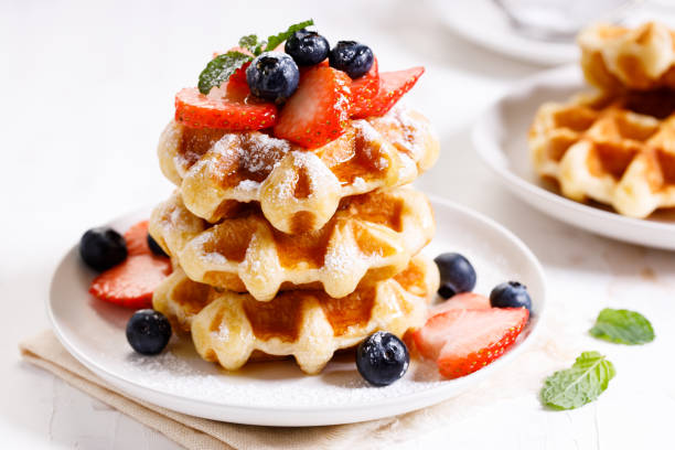 istock belgian waffles with fresh blueberries, strawberries and sugar. 1226711688