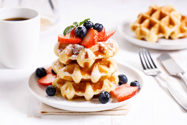 istock belgian waffles with fresh blueberries, strawberries and sugar. 1226711689