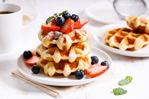 istock belgian waffles with fresh blueberries, strawberries and sugar. 1226711691