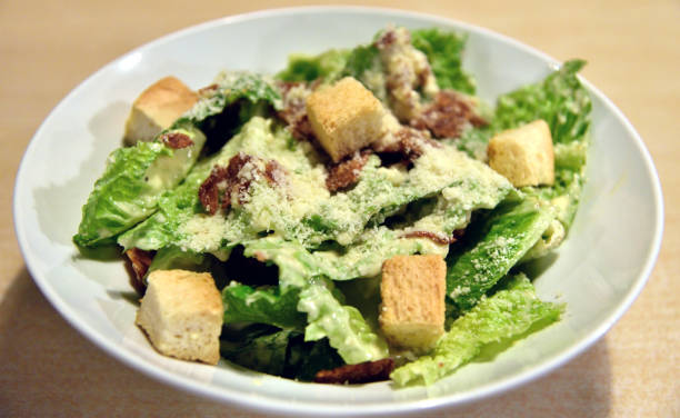istock Caesar salad on wooden table, High angle view 1226712050