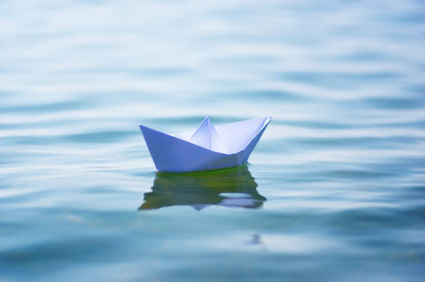 istock Paper boat on sea wave 1226713131