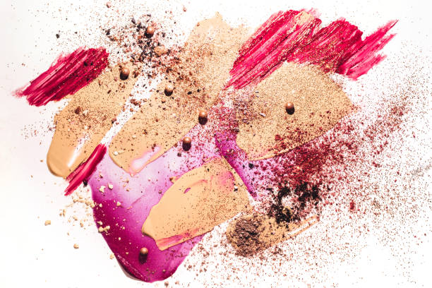 Beauty concept with Smudged makeup foundation, broken shadows, lip gloss and sparkles on white background