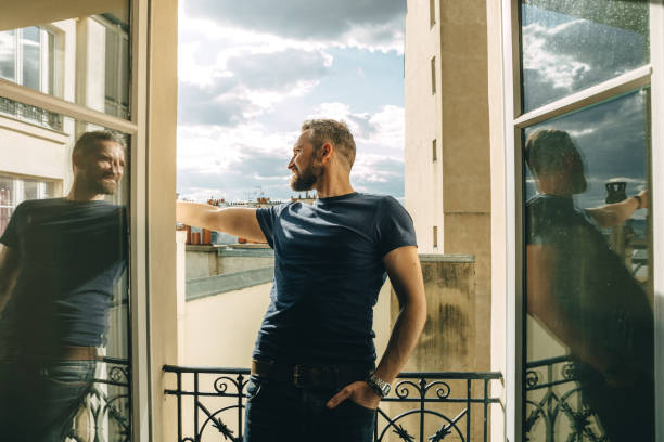 istock Man looking out over the city at sunrise 1226716430