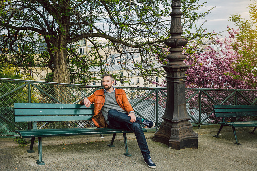 young man sitting on bench in Montmartre, Paris