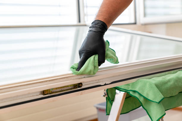 istock facility management cleaner cleaning a window and window frame with green micro fiber cloths 1226716514