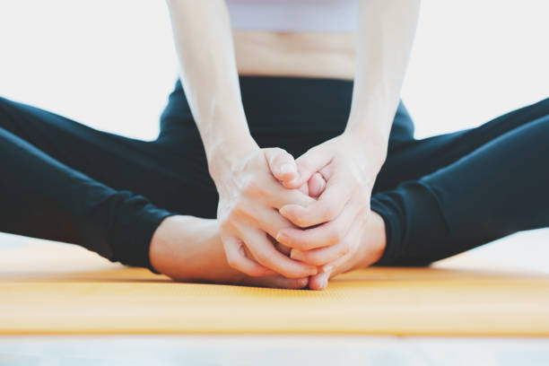istock young woman doing yoga on mat at home 1226716520